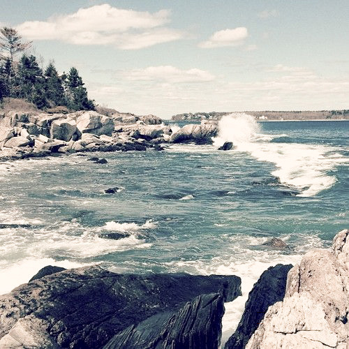 waves crash against a rocky Maine coast